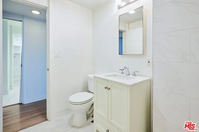 a bathroom with a sink toilet and a mirror