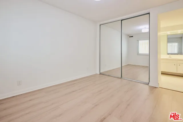 a view of an empty room and wooden floor