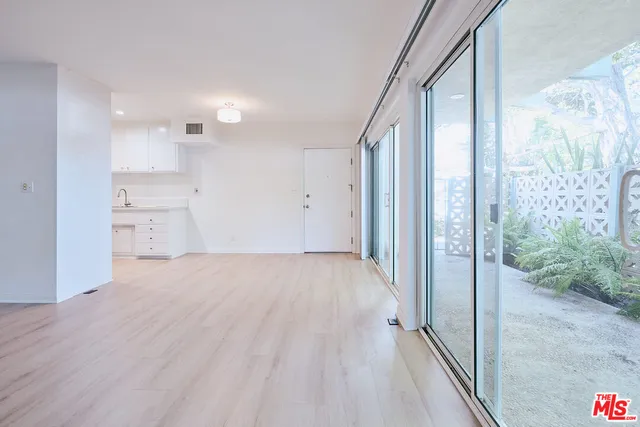 an empty room with a cabinet and a shower