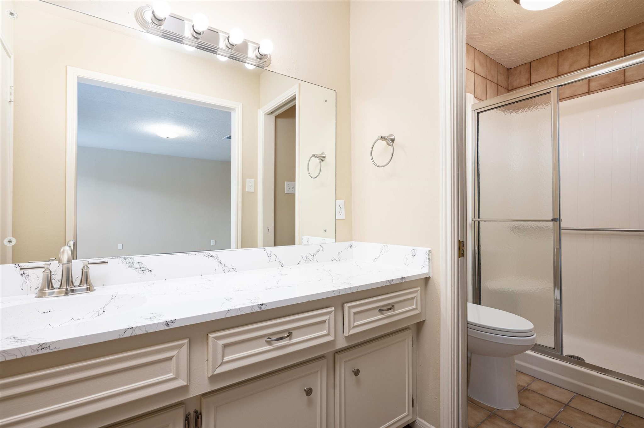 9306 Sanford Road Houston, TX 77031 - Photo 18 of 29 a bathroom with a granite countertop sink toilet and shower
