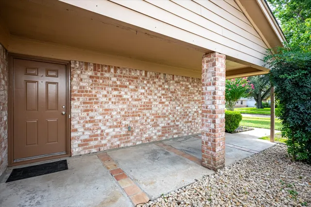 a view of hallway with wooden floor and a fireplace