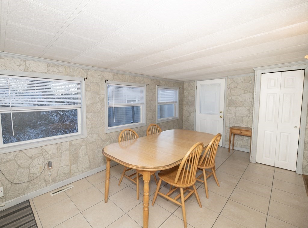 200 North Street, Unit 16C Danvers, MA 01923 - Photo 4 of 8 a view of a dining room with furniture and a window