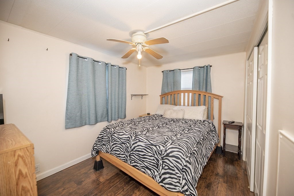 200 North Street, Unit 16C Danvers, MA 01923 - Photo 5 of 8 a bedroom with a bed and a chandelier