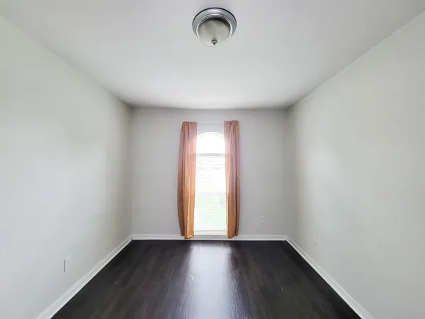 a view of room with window and hardwood floor