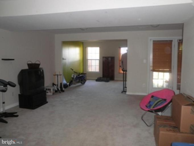4085 Jasper Loop Dumfries, VA 22025 - Photo 12 of 15 a living room with furniture and a gym machine
