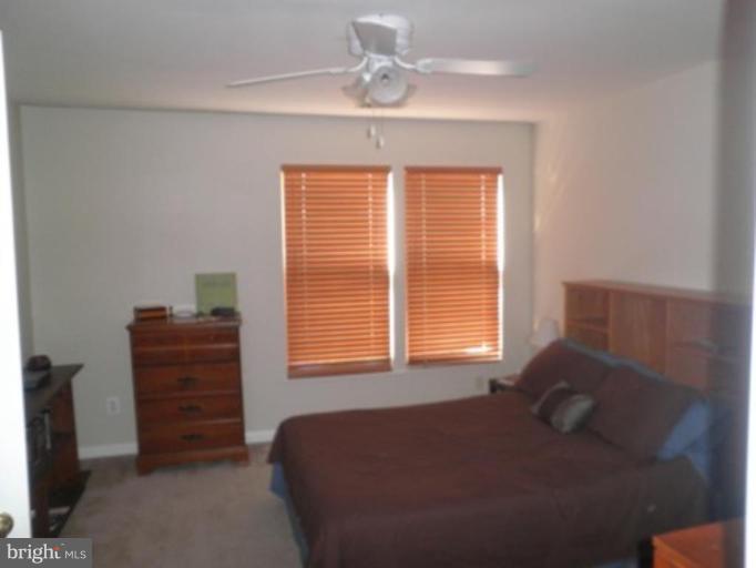 4085 Jasper Loop Dumfries, VA 22025 - Photo 6 of 15 a bedroom with a bed and a window