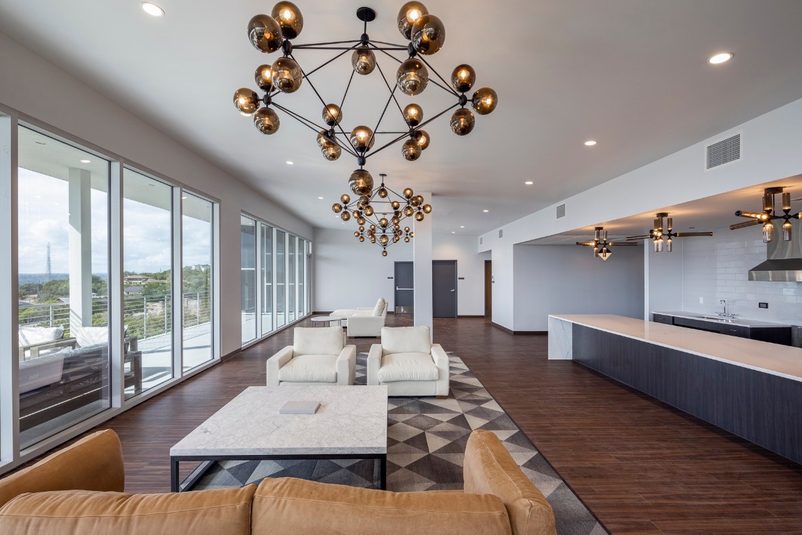 4229 North FM 620, Unit 120 Austin, TX 78734 - Photo 9 of 14 a living room with couches chandelier and a large window
