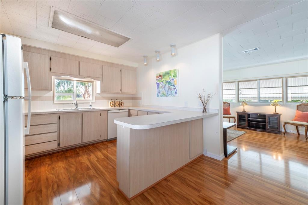 10011 110th Place, Unit 246 Largo, FL 33773 - Photo 11 of 31 a kitchen with a sink window and cabinets