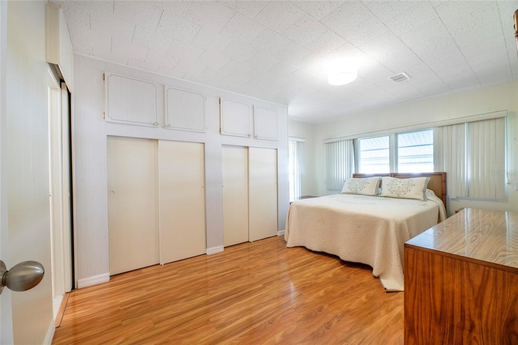 10011 110th Place, Unit 246 Largo, FL 33773 - Photo 12 of 31 a spacious bedroom with a bed and a dresser