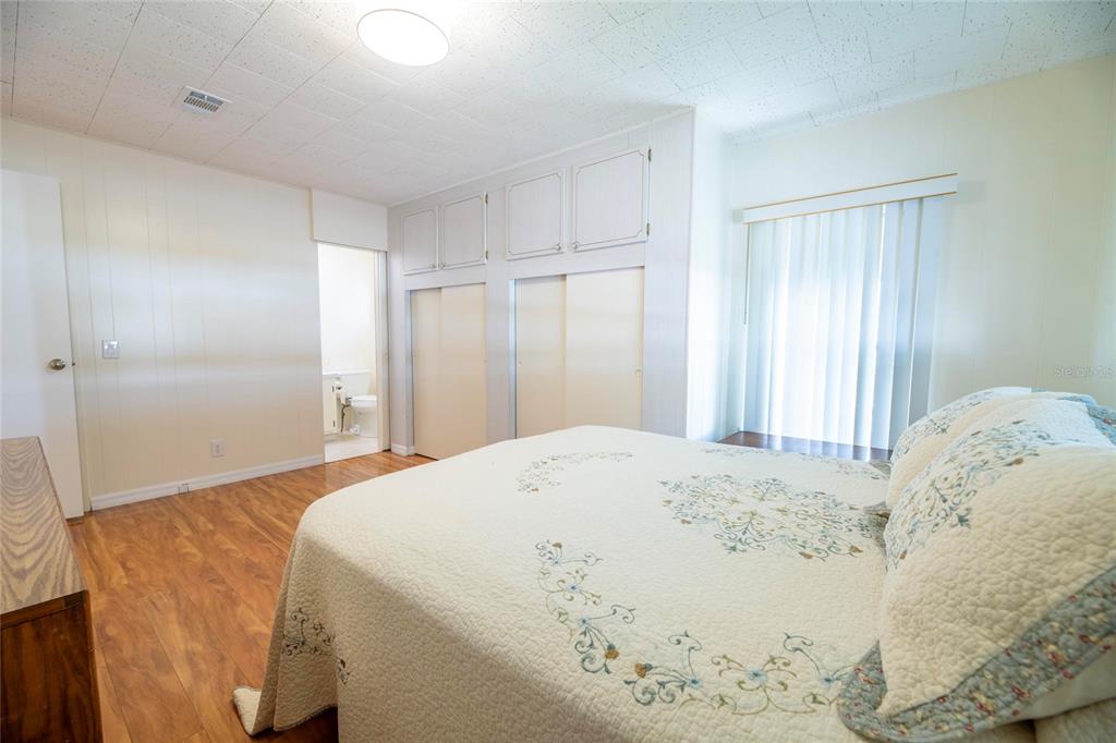 10011 110th Place, Unit 246 Largo, FL 33773 - Photo 18 of 31 a bedroom with a bed and a window
