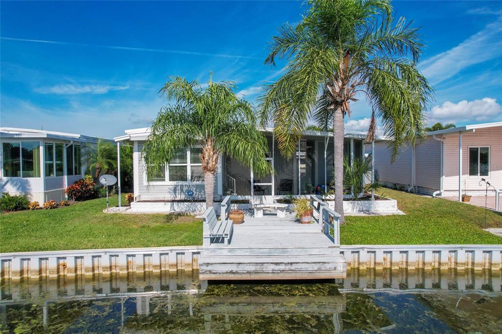 10011 110th Place, Unit 246 Largo, FL 33773 - Photo 2 of 31 a view of a house with swimming pool and a yard