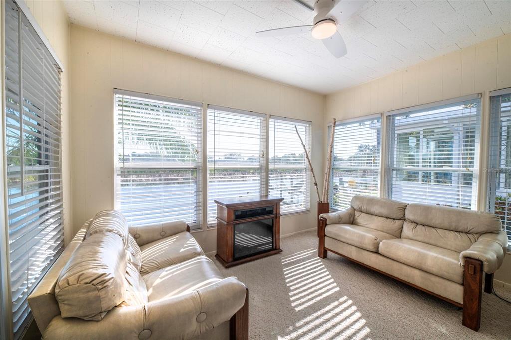 10011 110th Place, Unit 246 Largo, FL 33773 - Photo 21 of 31 a living room with furniture and a large window