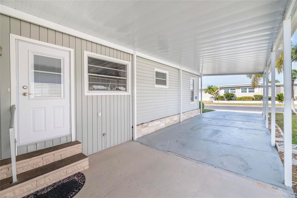 10011 110th Place, Unit 246 Largo, FL 33773 - Photo 22 of 31 a view of a hallway with an outdoor space