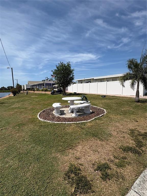 10011 110th Place, Unit 246 Largo, FL 33773 - Photo 30 of 31 a view of a swimming pool with a yard
