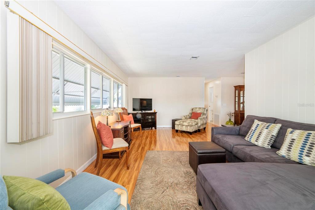 10011 110th Place, Unit 246 Largo, FL 33773 - Photo 7 of 31 a living room with furniture and a large window
