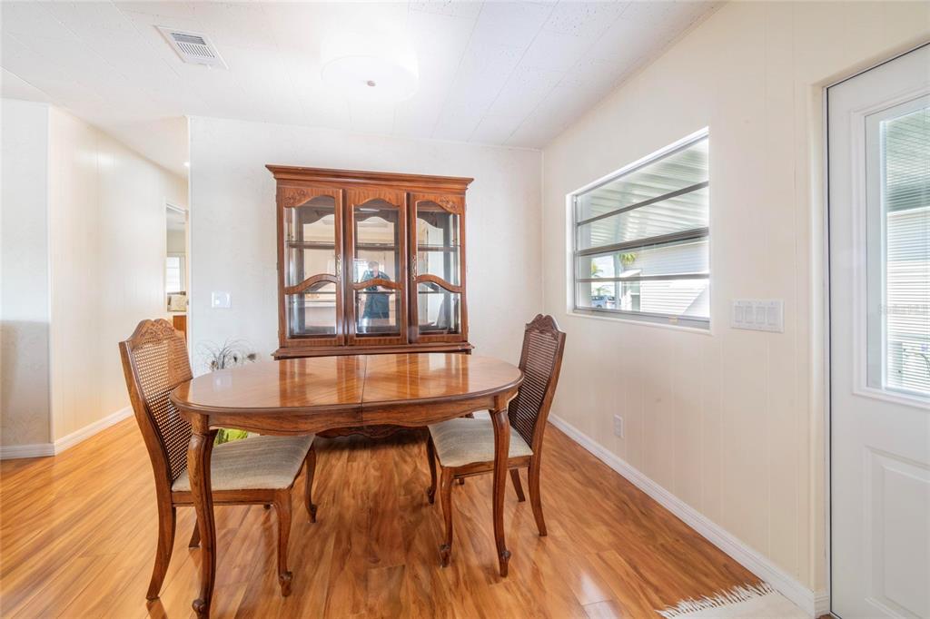 10011 110th Place, Unit 246 Largo, FL 33773 - Photo 9 of 31 a view of a dining room with furniture and wooden floor