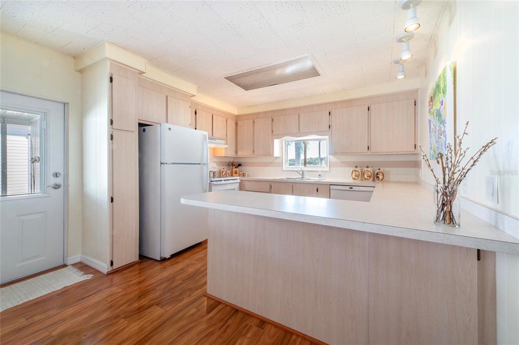 10011 110th Place, Unit 246 Largo, FL 33773 - Photo 10 of 31 a kitchen with stainless steel appliances granite countertop a refrigerator and a stove top oven