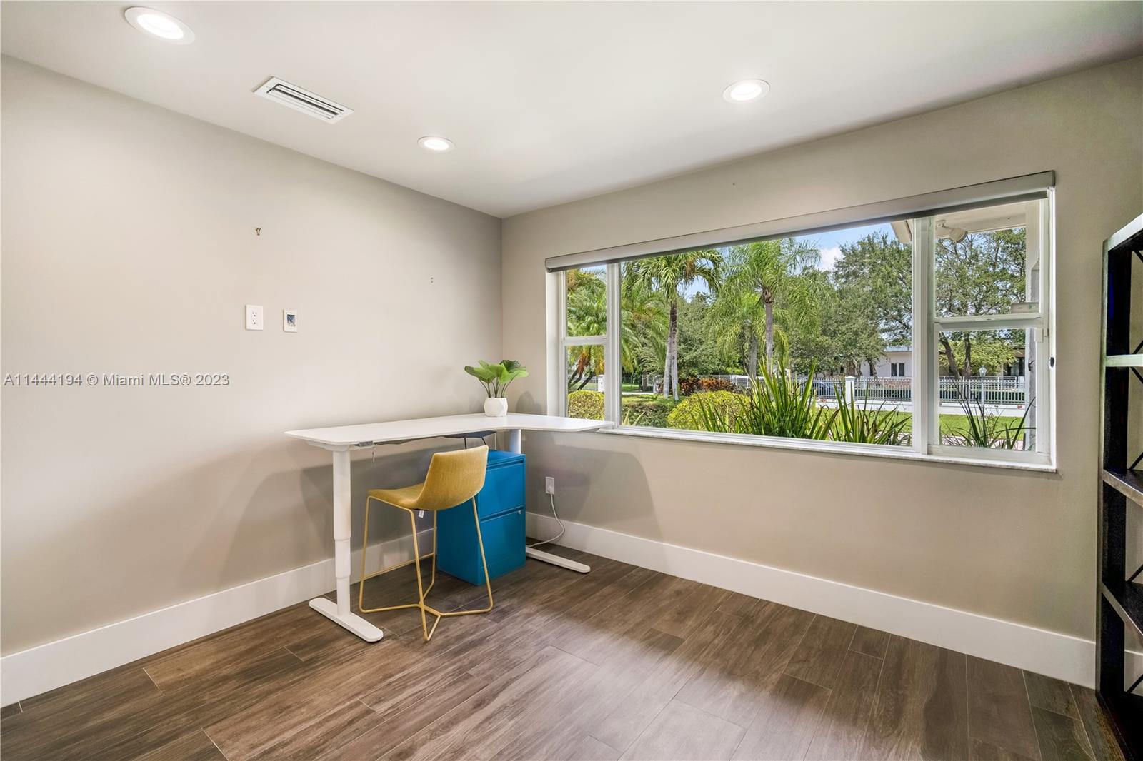 7900 Southwest 129th Terrace Pinecrest, FL 33156 - Photo 17 of 57 a view of an empty room with wooden floor and a window