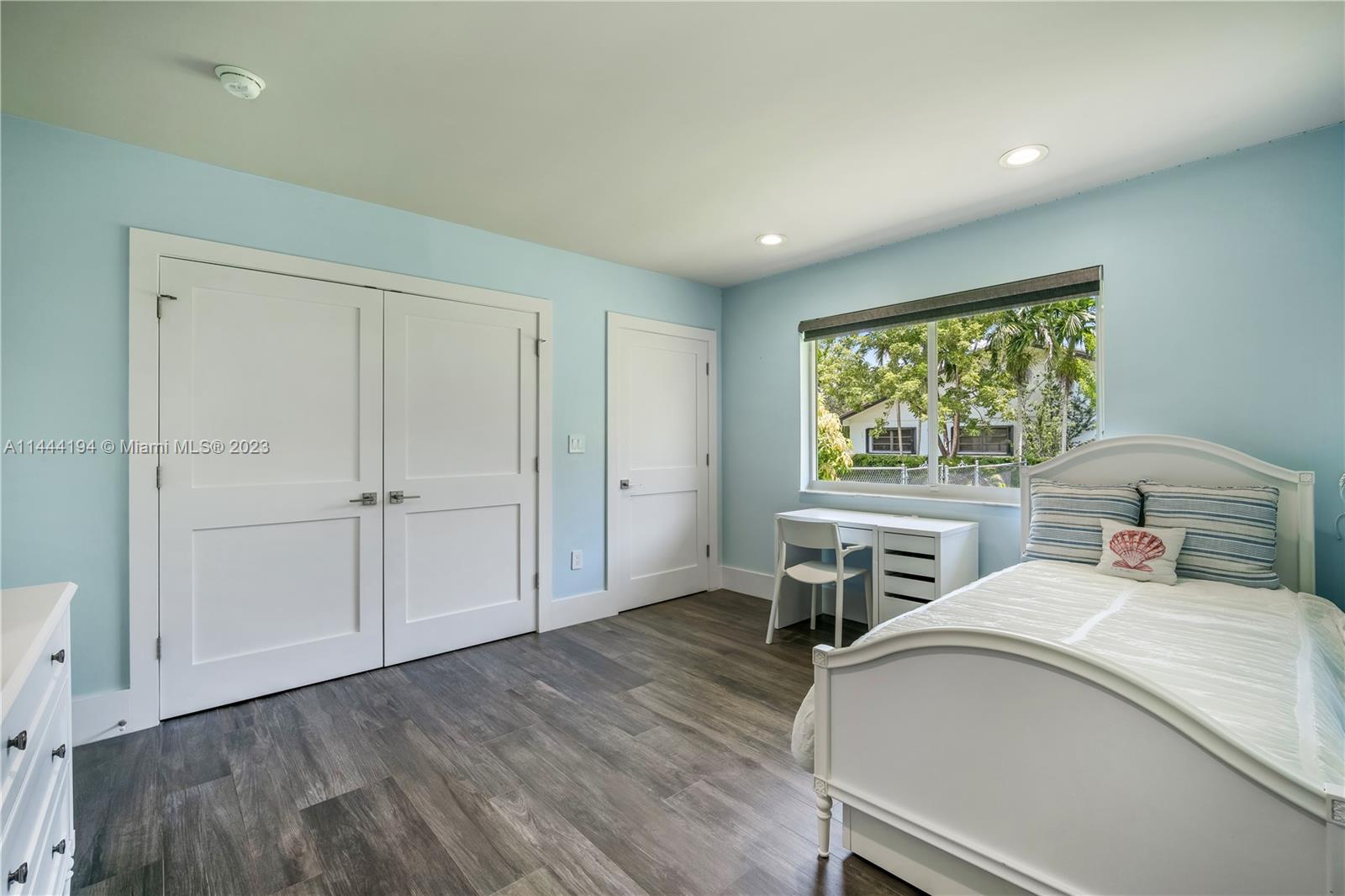 7900 Southwest 129th Terrace Pinecrest, FL 33156 - Photo 22 of 57 a bedroom with a bed and a table in it