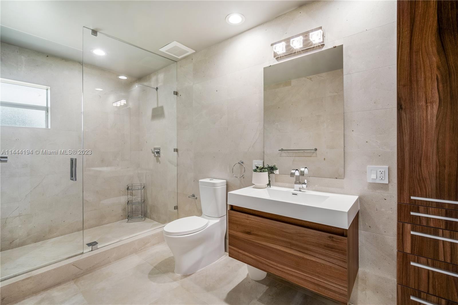 7900 Southwest 129th Terrace Pinecrest, FL 33156 - Photo 23 of 57 a bathroom with a sink a toilet and shower