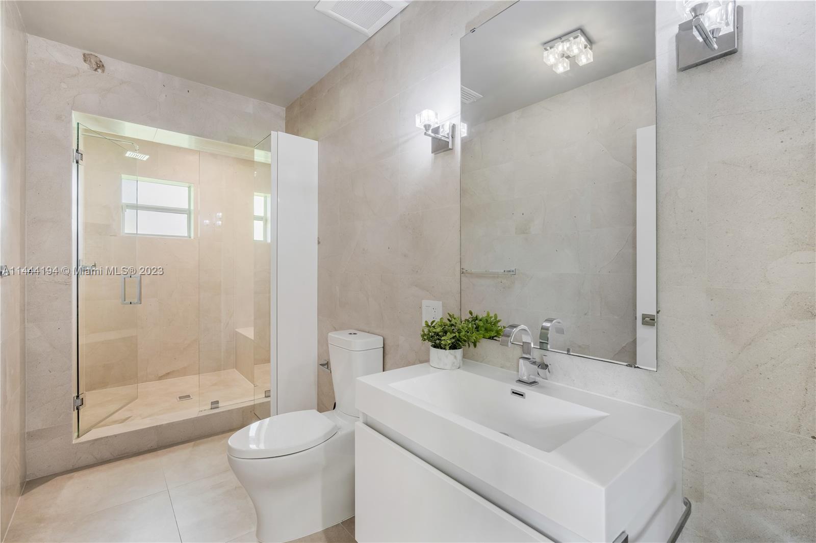 7900 Southwest 129th Terrace Pinecrest, FL 33156 - Photo 25 of 57 a bathroom with a sink toilet and shower