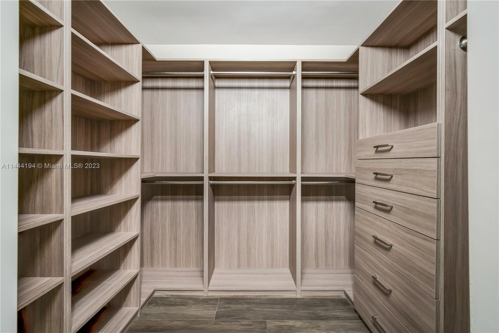 7900 Southwest 129th Terrace Pinecrest, FL 33156 - Photo 29 of 57 a view of walk in closet with empty racks