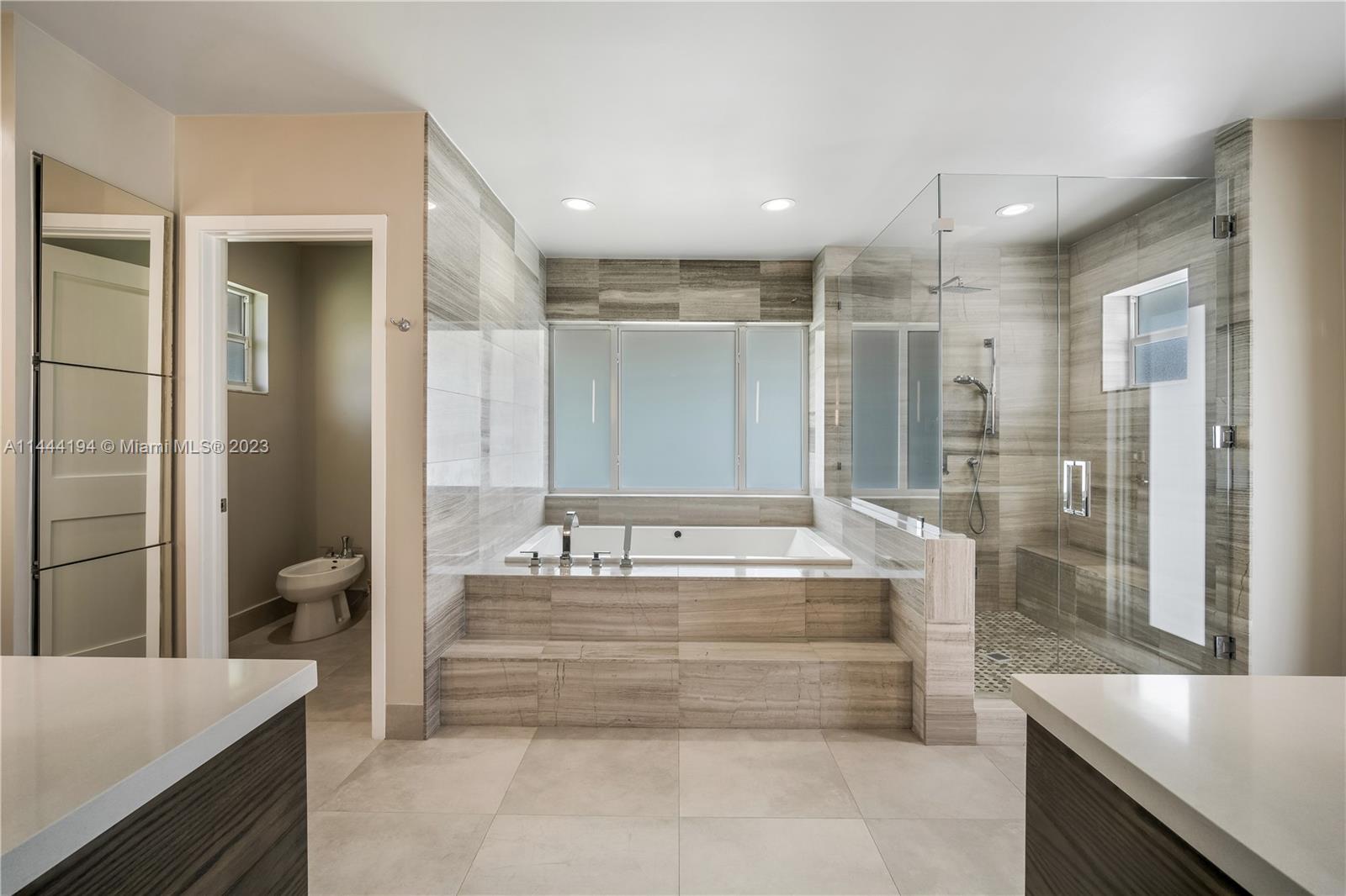 7900 Southwest 129th Terrace Pinecrest, FL 33156 - Photo 31 of 57 a spacious bathroom with a tub shower and sink