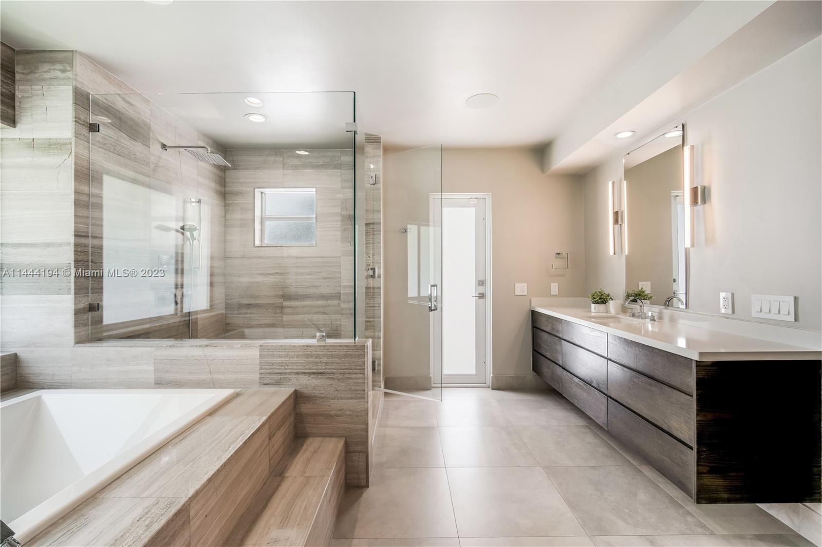 7900 Southwest 129th Terrace Pinecrest, FL 33156 - Photo 33 of 57 a bathroom with a bathtub a sink and a shower