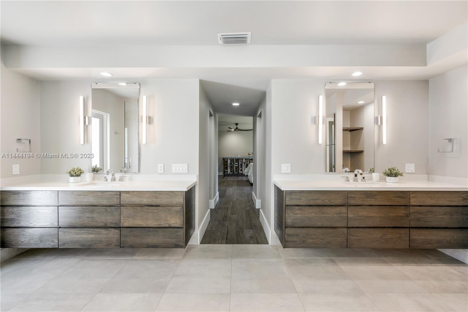 7900 Southwest 129th Terrace Pinecrest, FL 33156 - Photo 35 of 57 a bathroom with a sink double vanity and a mirror