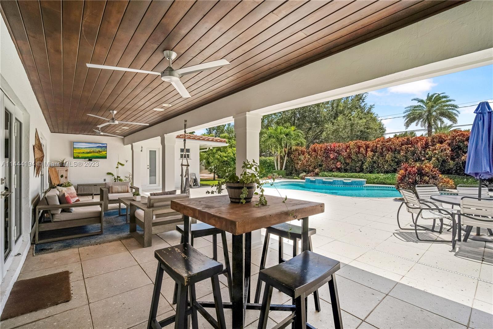 7900 Southwest 129th Terrace Pinecrest, FL 33156 - Photo 37 of 57 a view of a patio with a backyard table and chairs