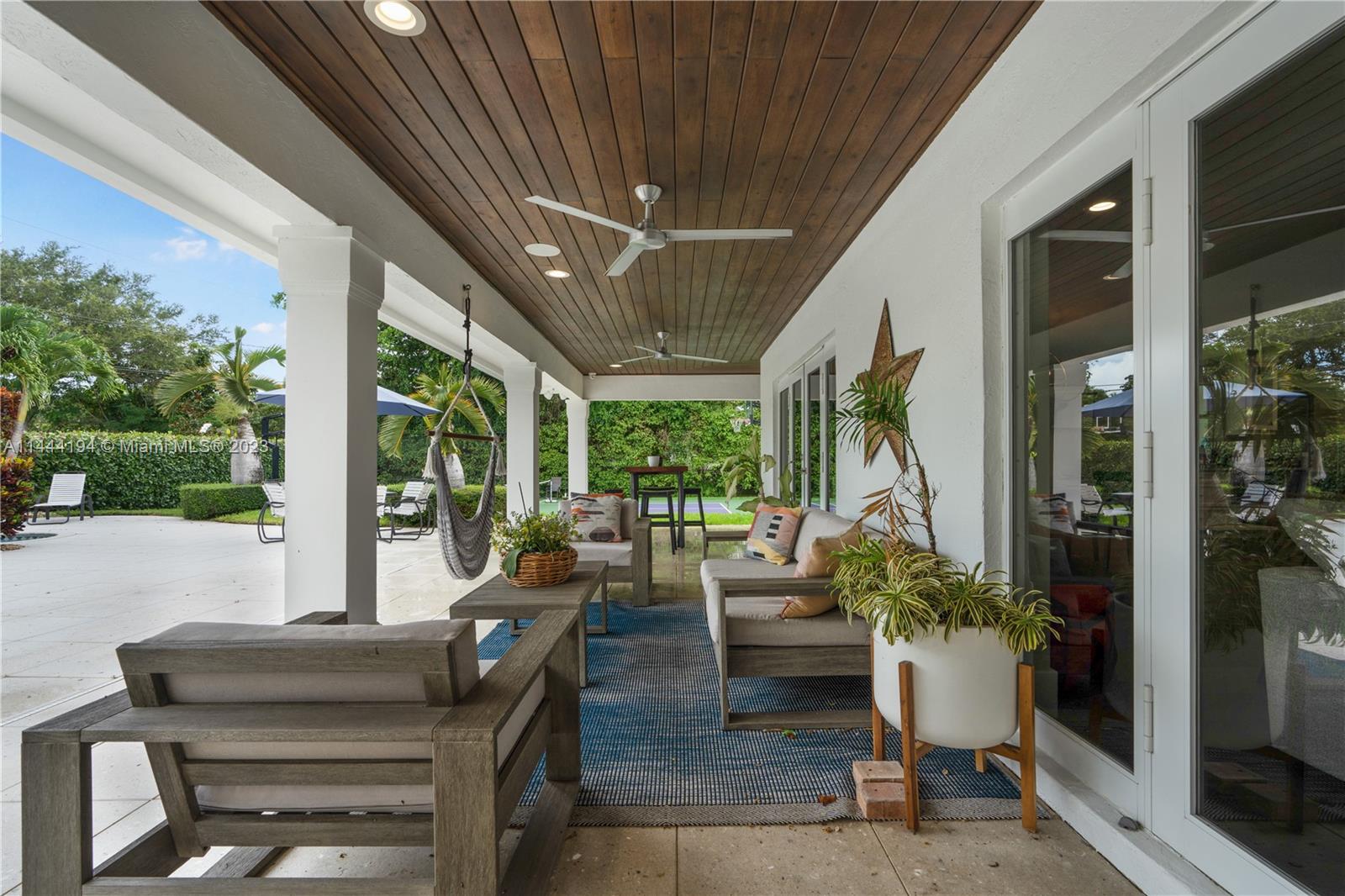 7900 Southwest 129th Terrace Pinecrest, FL 33156 - Photo 39 of 57 a living room with patio furniture and garden view