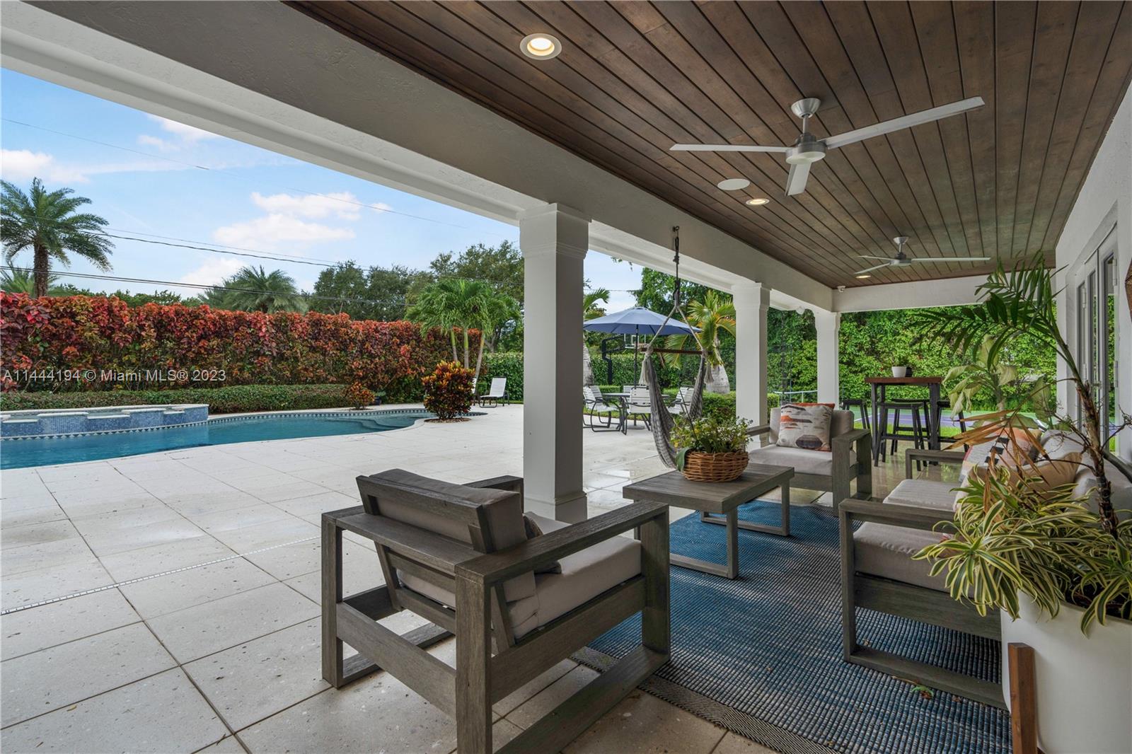 7900 Southwest 129th Terrace Pinecrest, FL 33156 - Photo 40 of 57 a outdoor living space with furniture and garden view