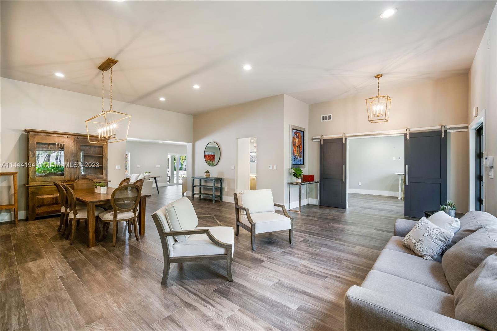 7900 Southwest 129th Terrace Pinecrest, FL 33156 - Photo 4 of 57 a living room with furniture and wooden floor