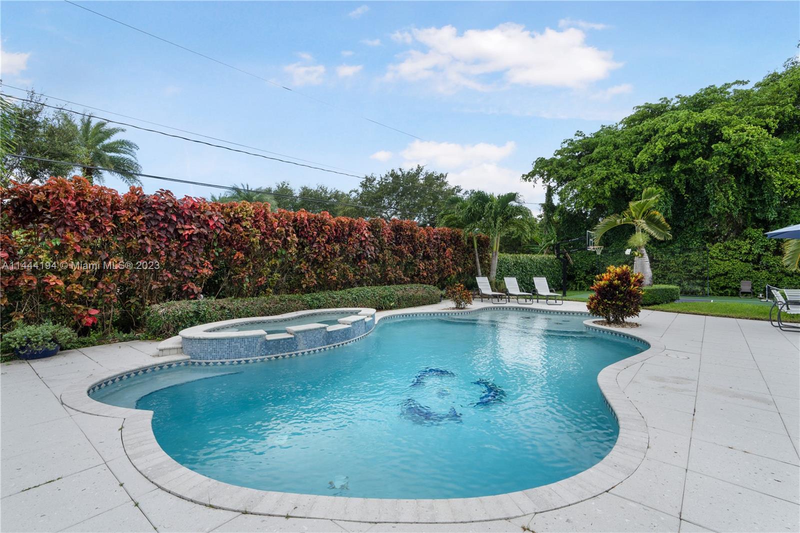7900 Southwest 129th Terrace Pinecrest, FL 33156 - Photo 41 of 57 a view of a swimming pool with a patio