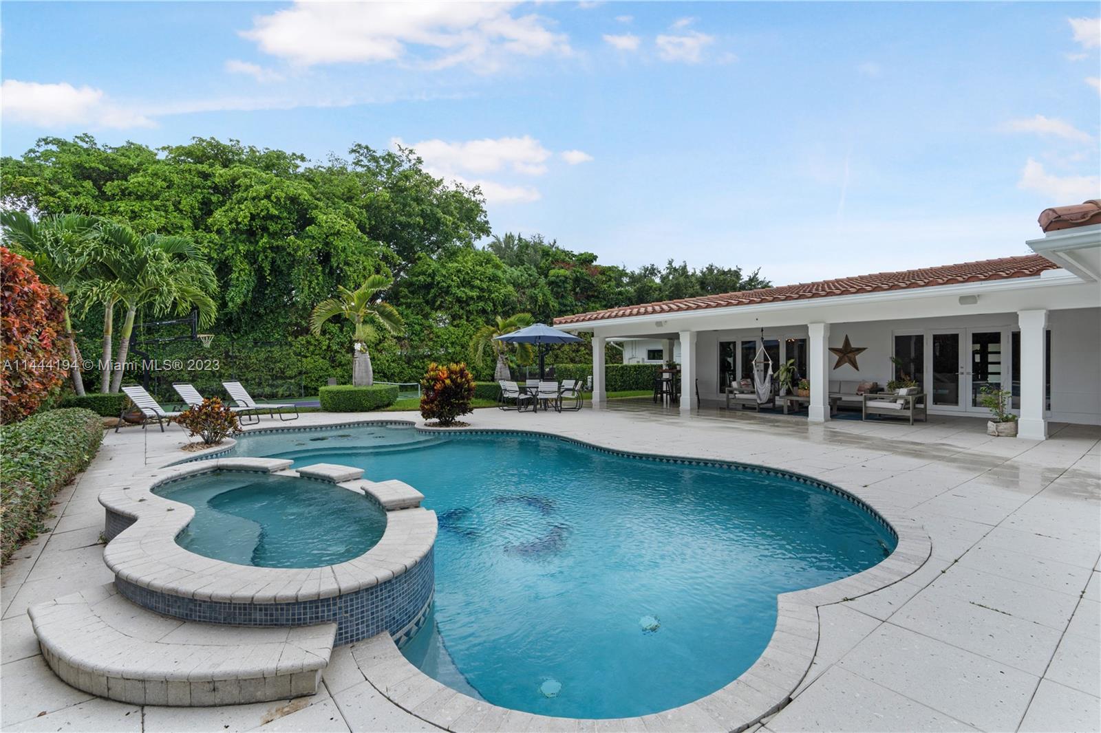 7900 Southwest 129th Terrace Pinecrest, FL 33156 - Photo 45 of 57 a view of a house with swimming pool fire pit and chairs