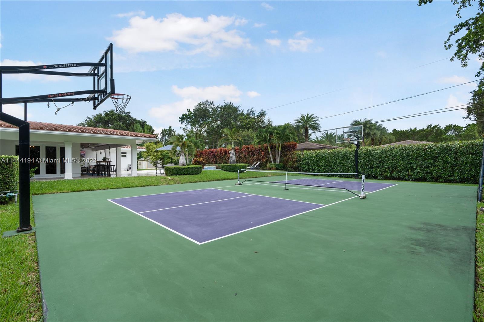 7900 Southwest 129th Terrace Pinecrest, FL 33156 - Photo 46 of 57 a front view of a house with a yard