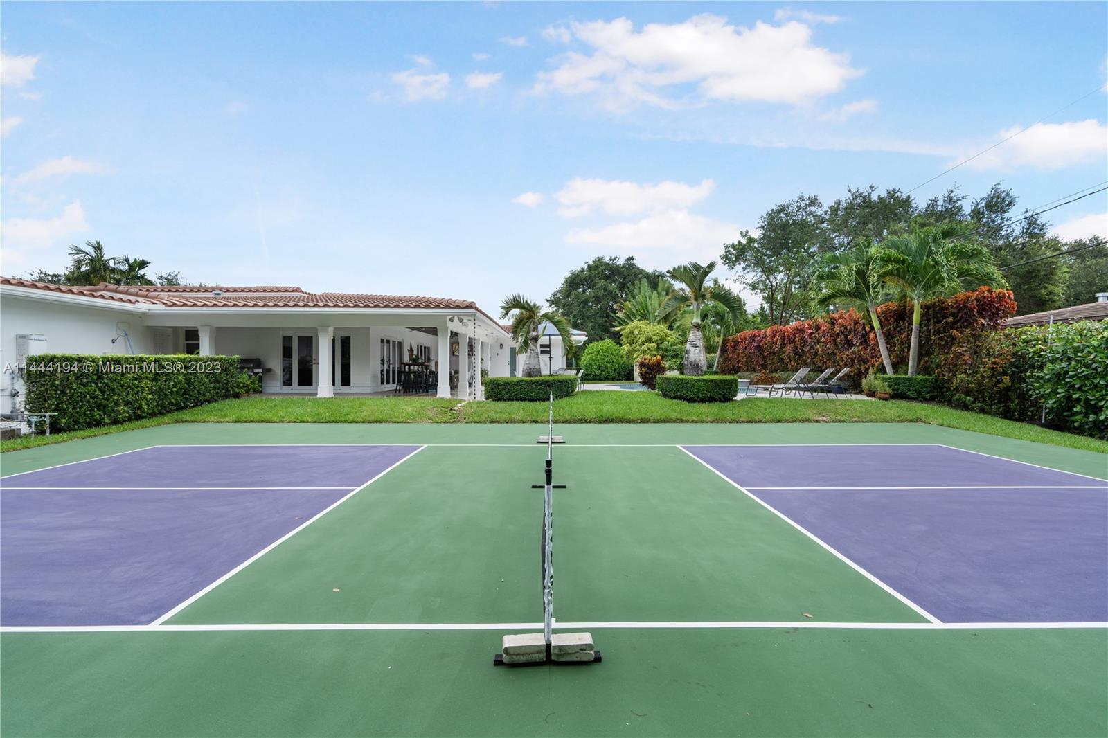 7900 Southwest 129th Terrace Pinecrest, FL 33156 - Photo 47 of 57 a view of a tennis ground with large trees