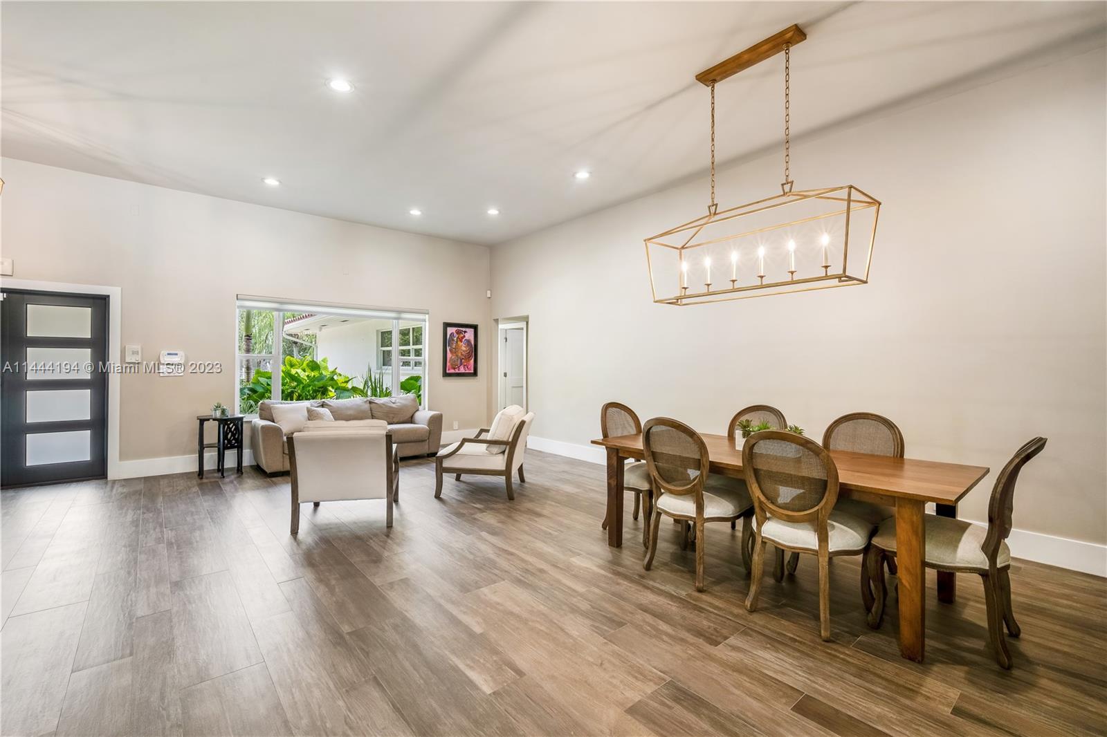 7900 Southwest 129th Terrace Pinecrest, FL 33156 - Photo 5 of 57 a view of a dining room with furniture window and wooden floor