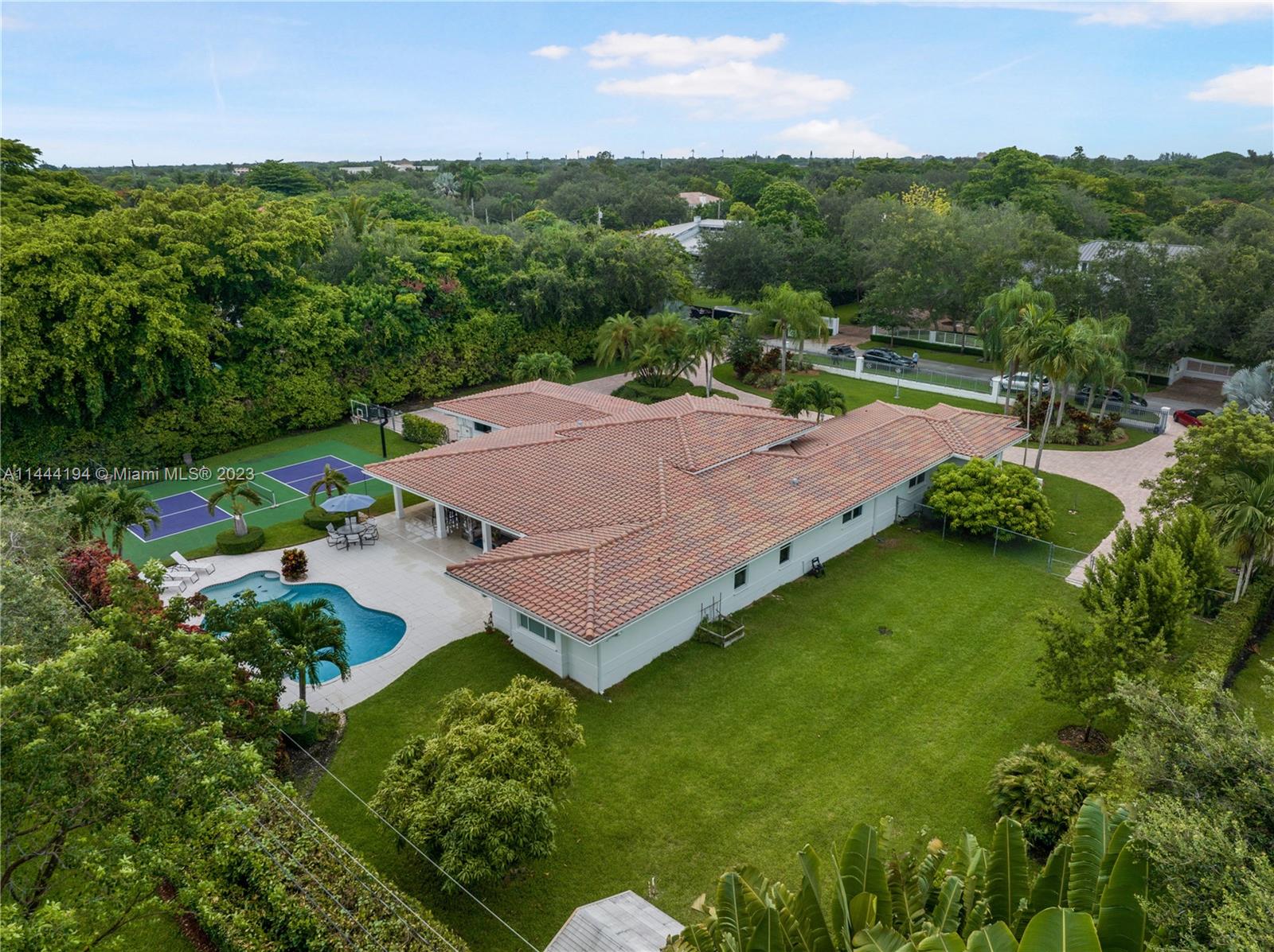 7900 Southwest 129th Terrace Pinecrest, FL 33156 - Photo 54 of 57 an aerial view of a house with a yard