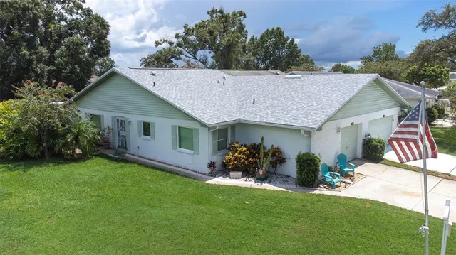 a view of a house with roof deck and a garden