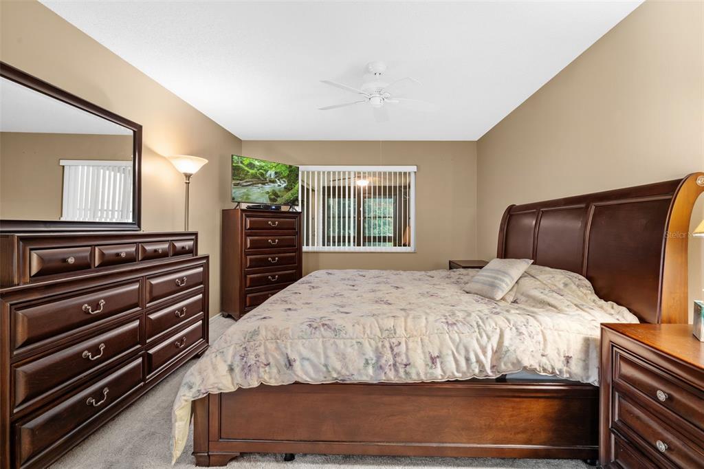 3201 McMath Drive Palm Harbor, FL 34684 - Photo 25 of 59 a bedroom with a bed and a television