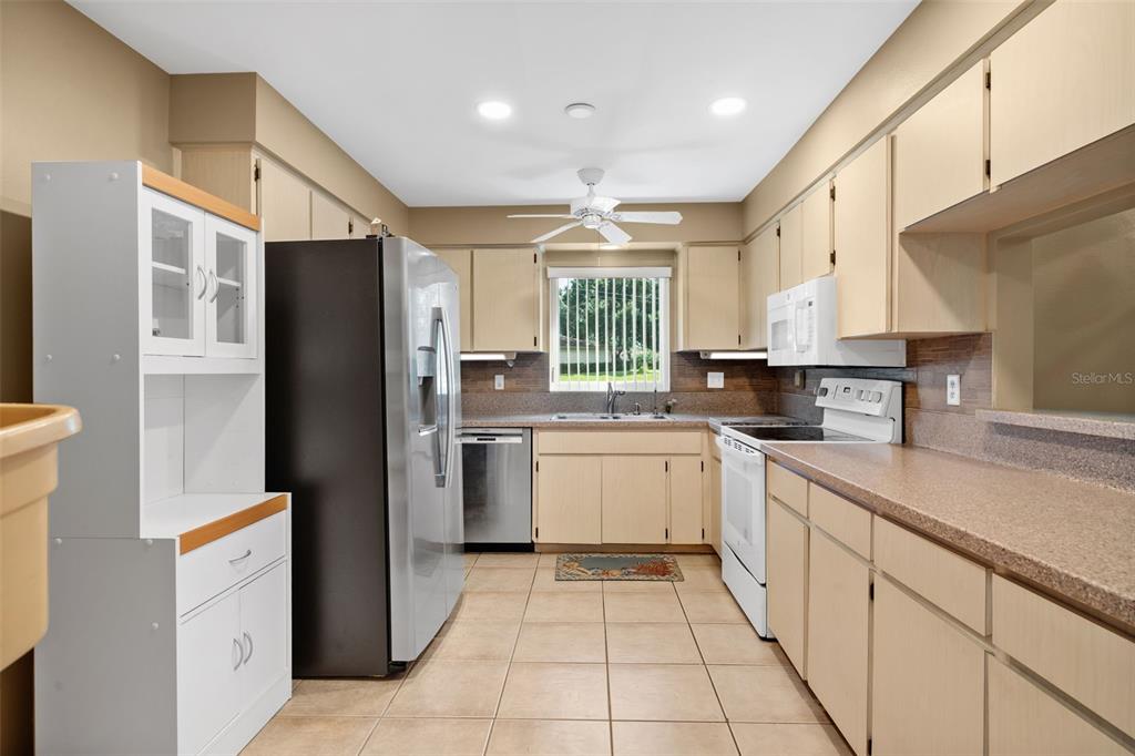 3201 McMath Drive Palm Harbor, FL 34684 - Photo 30 of 59 a kitchen with a refrigerator a sink and dishwasher