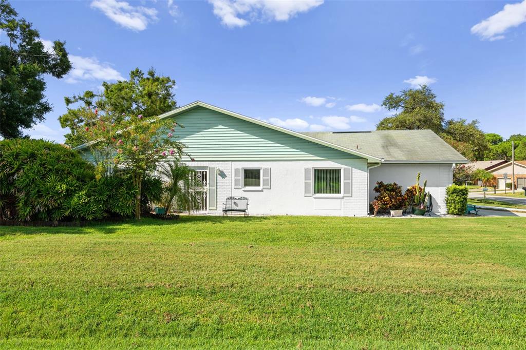 3201 McMath Drive Palm Harbor, FL 34684 - Photo 6 of 59 a front view of a house with a garden