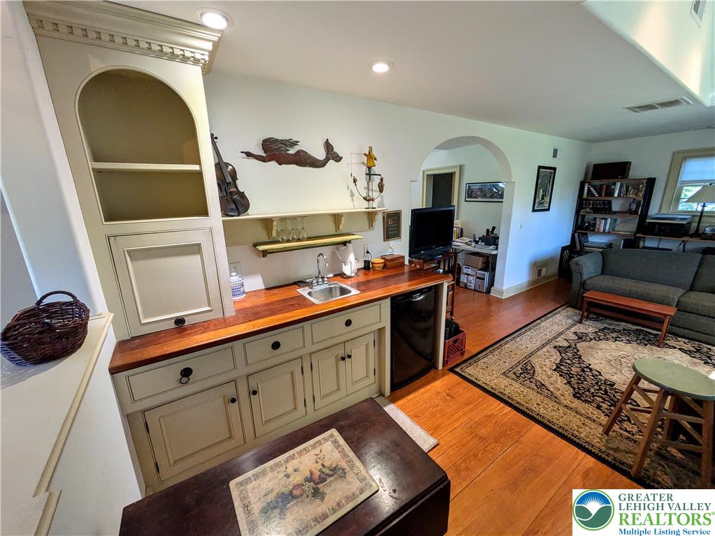 1731 Howell Road Easton, PA 18040 - Photo 33 of 60 Gleaming hardwood floors and a built-in wet bar define this versatile open living space.