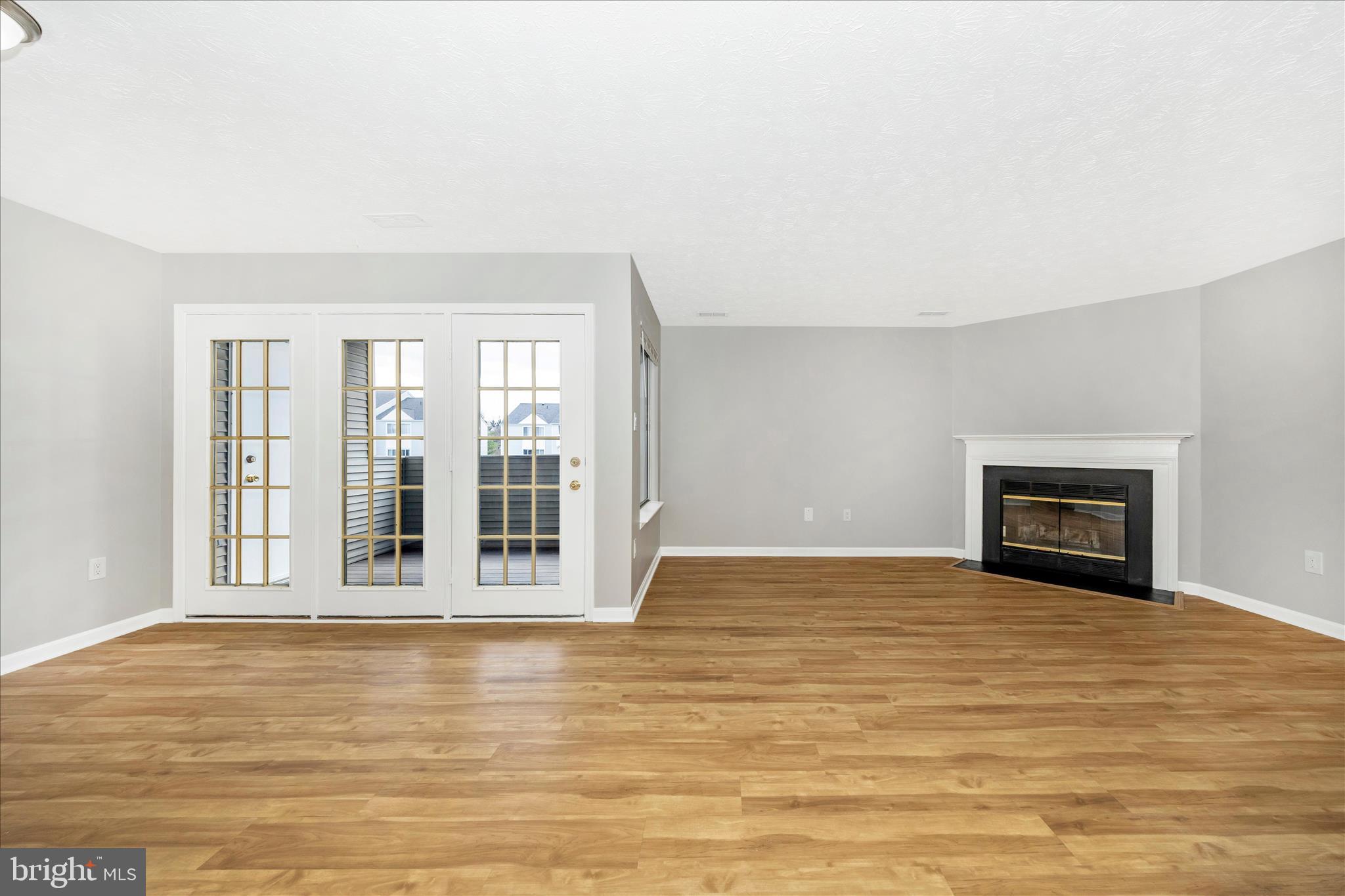 2137 Wainwright Court, Unit 1B Frederick, MD 21702 - Photo 15 of 55 a view of an empty room with wooden floor and a window