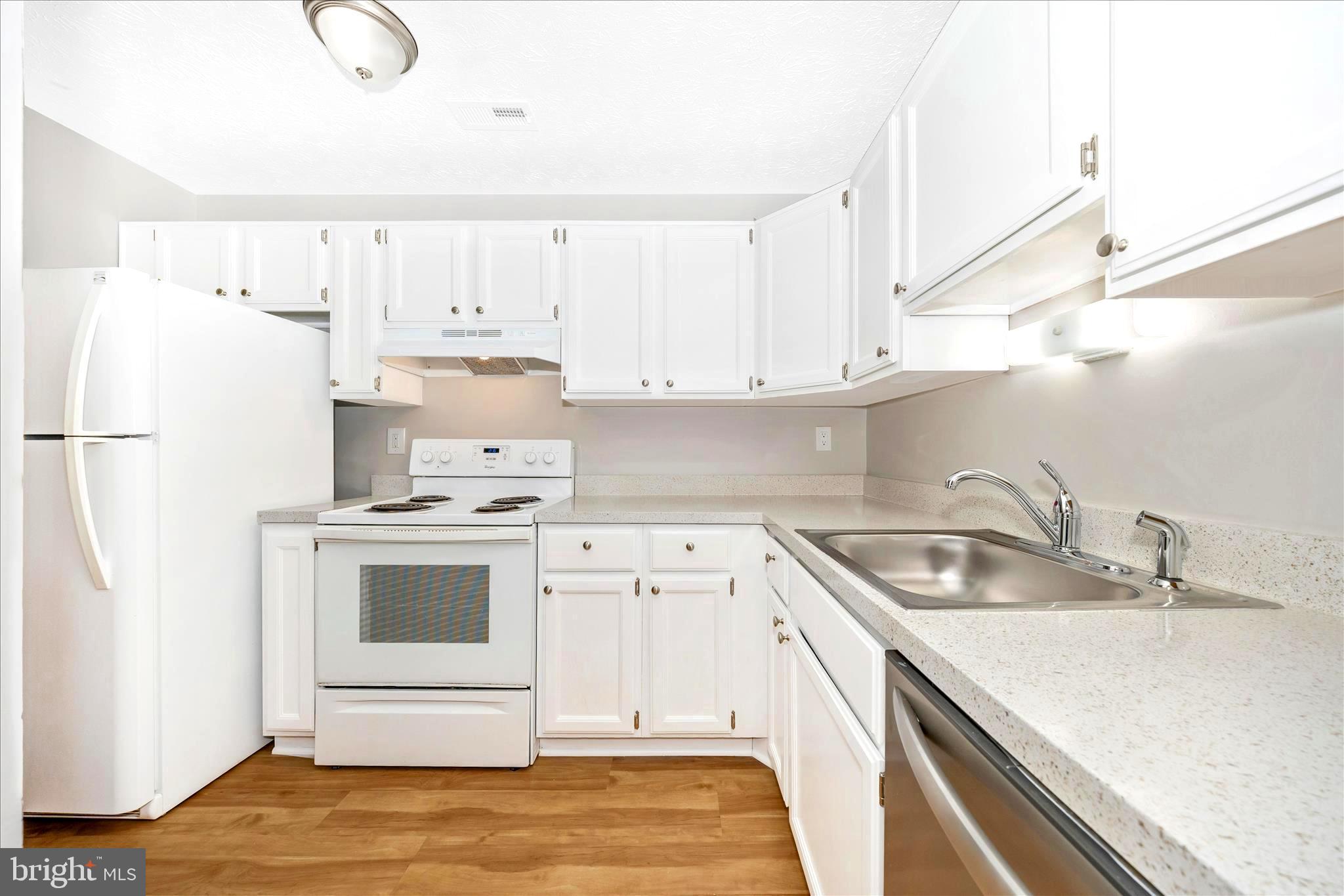 2137 Wainwright Court, Unit 1B Frederick, MD 21702 - Photo 16 of 55 a kitchen with granite countertop a sink and a stove