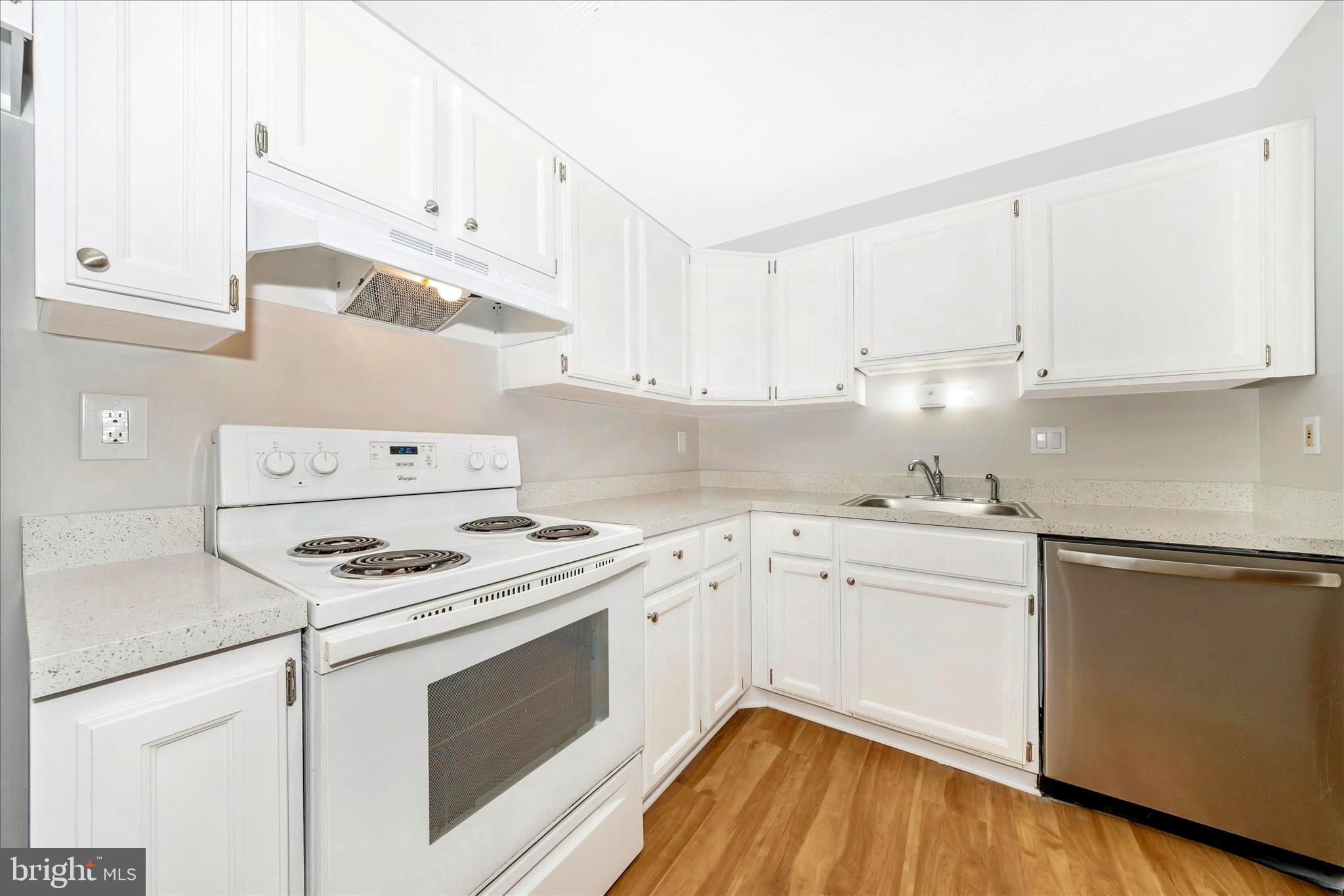 2137 Wainwright Court, Unit 1B Frederick, MD 21702 - Photo 18 of 55 a kitchen with cabinets appliances and a wooden floor