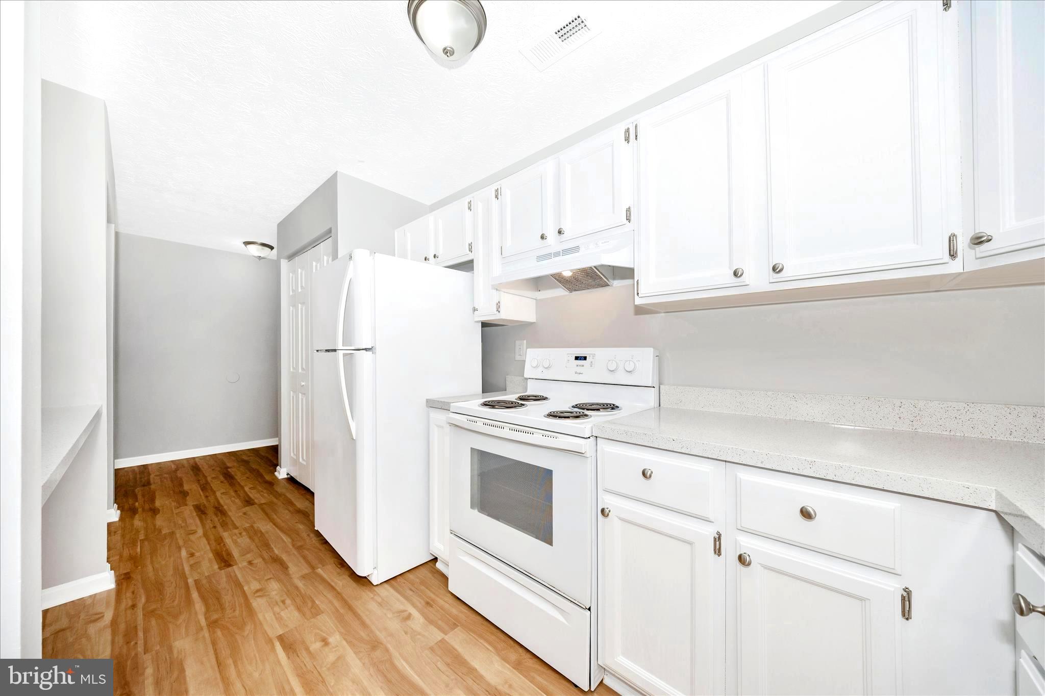 2137 Wainwright Court, Unit 1B Frederick, MD 21702 - Photo 20 of 55 a kitchen with a white cabinets and white appliances