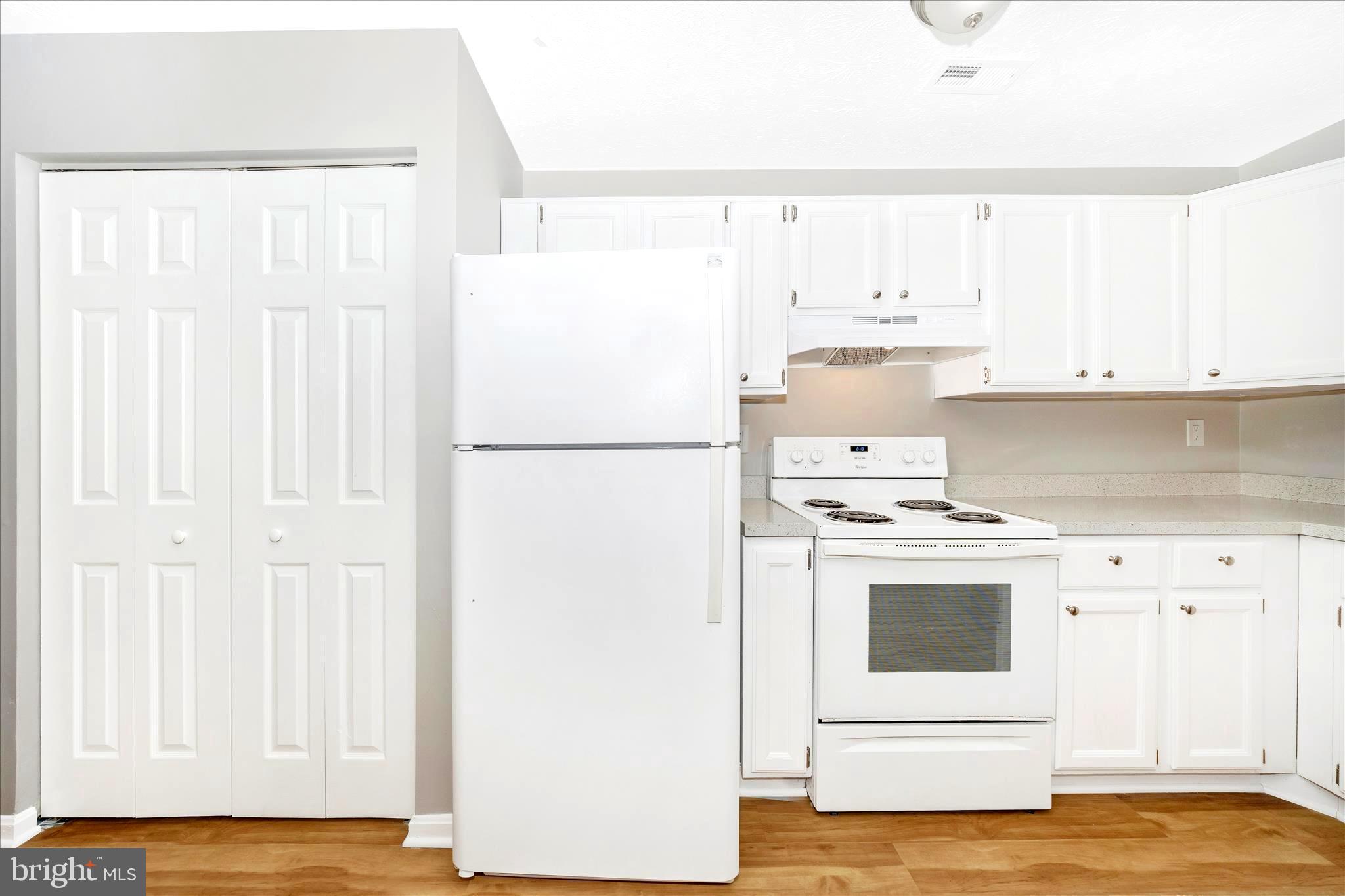 2137 Wainwright Court, Unit 1B Frederick, MD 21702 - Photo 21 of 55 a kitchen with a white cabinets and white appliances