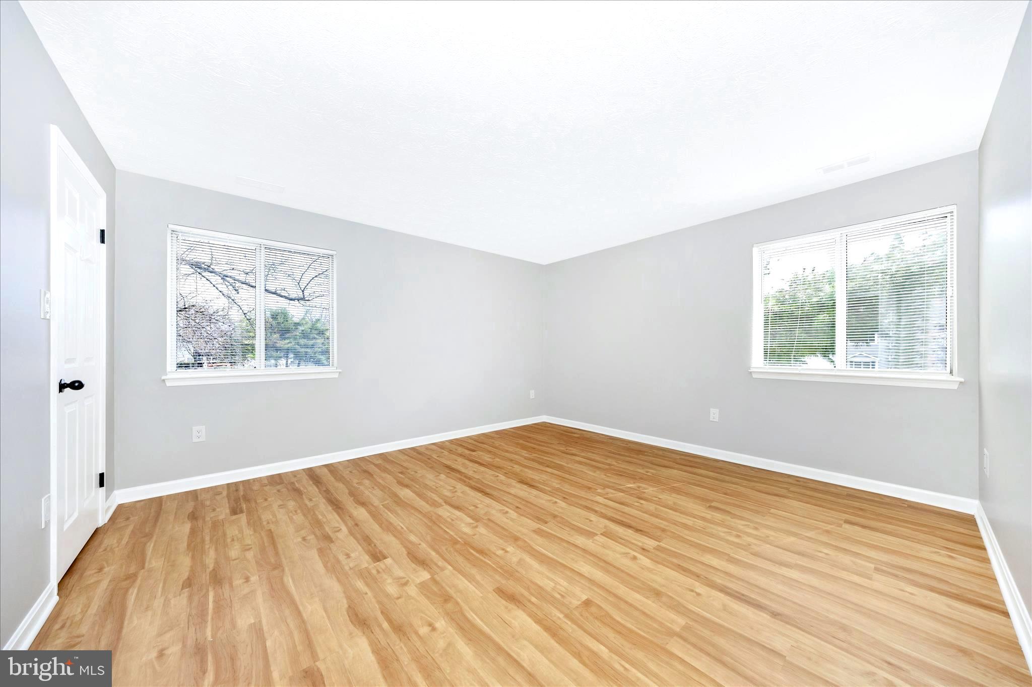 2137 Wainwright Court, Unit 1B Frederick, MD 21702 - Photo 24 of 55 an empty room with wooden floor and windows